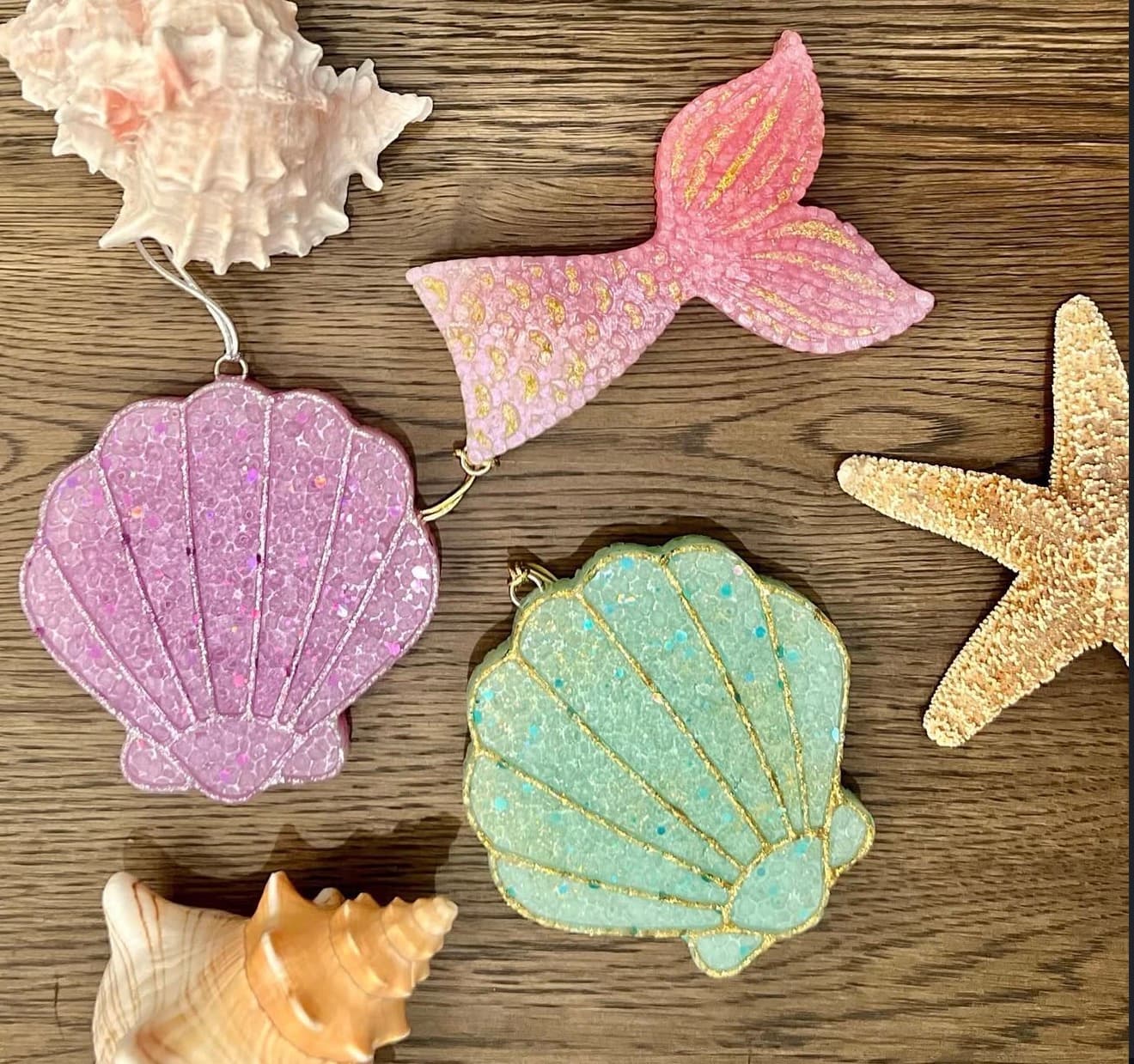 Mermaid-themed air fresheners including glittery seashells and a pink mermaid tail with real shells and starfish